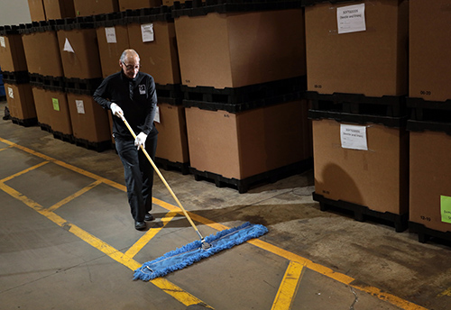 Janitor Sweeping Warehouse