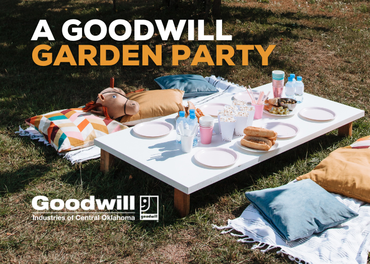Table with garden party essentials and pillows surrounding it on a grassy surface. Title says 'A Goodwill Garden party'